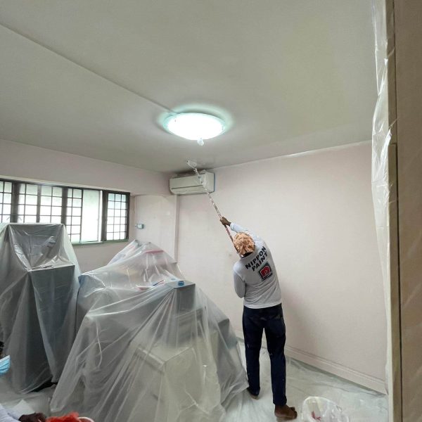 Painter painting ceiling of a HDB Flat